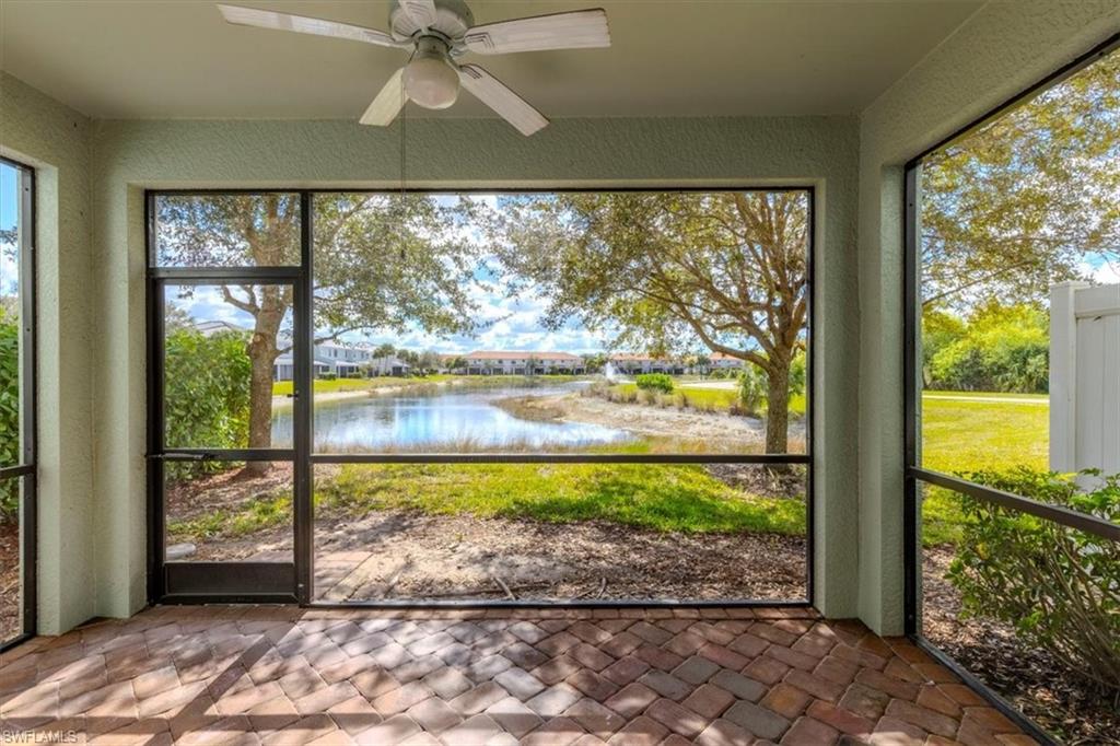 15389 Summit Pl Circle, Unit 286 Naples, FL 34119 - Photo 4 of 29 Unfurnished sunroom with ceiling fan and a water view