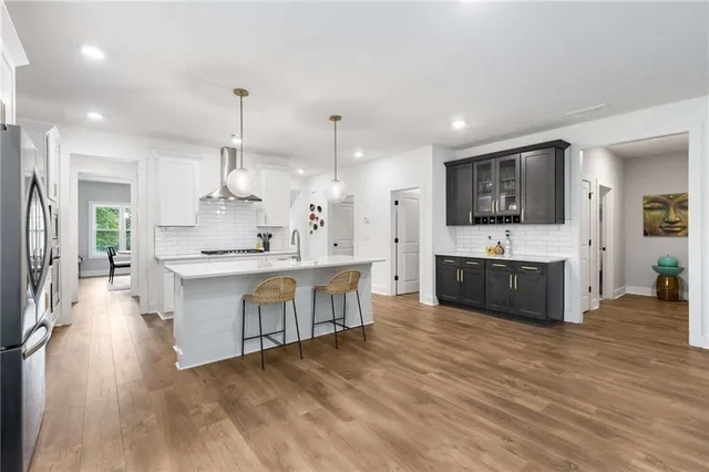 a large kitchen with kitchen island a sink stainless steel appliances and cabinets
