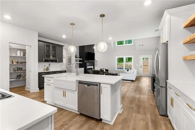 a large kitchen with cabinets and stainless steel appliances