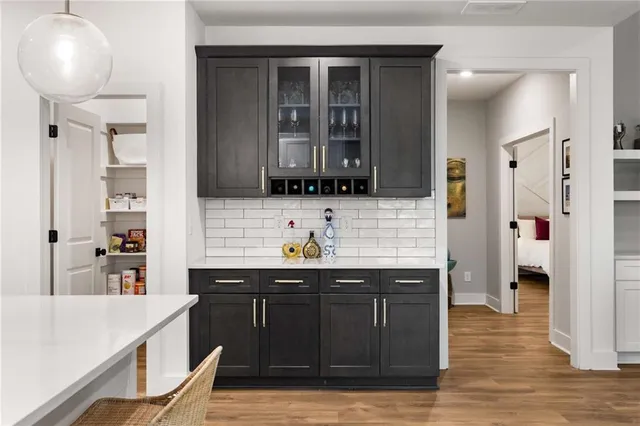 a kitchen with a sink cabinets and wooden floor