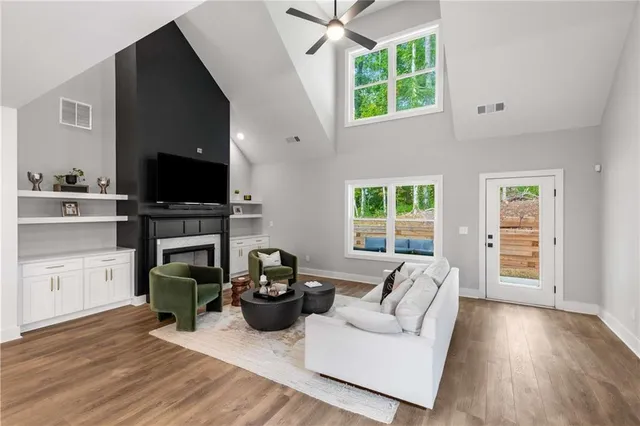 a living room with furniture a flat screen tv and a fireplace