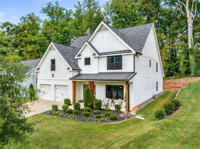 a front view of a house with a yard and porch
