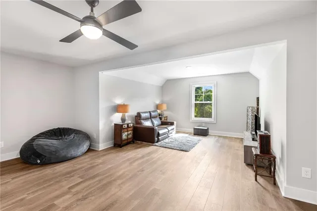 a view of a livingroom with furniture and a ceiling fan