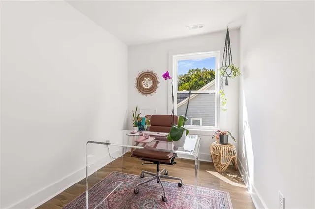 a living room with furniture a rug and a flat screen tv