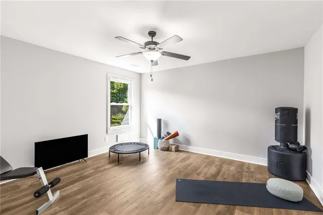 a view of a room with a piano and wooden floor