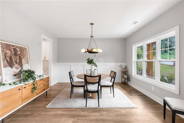 a dining room with furniture a window and wooden floor
