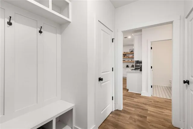 a view of a hallway with wooden floor