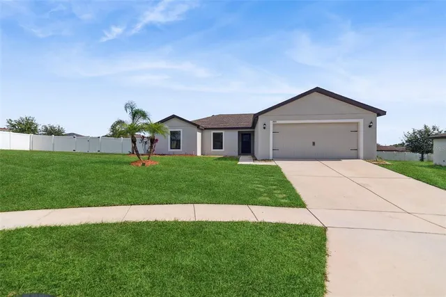a front view of a house with a garden and yard