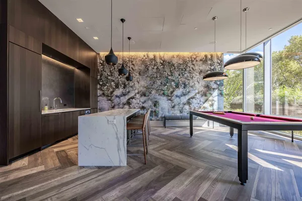 a living room with furniture a flat screen tv and a wooden floor