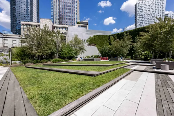 a view of a swimming pool with a bench and yard
