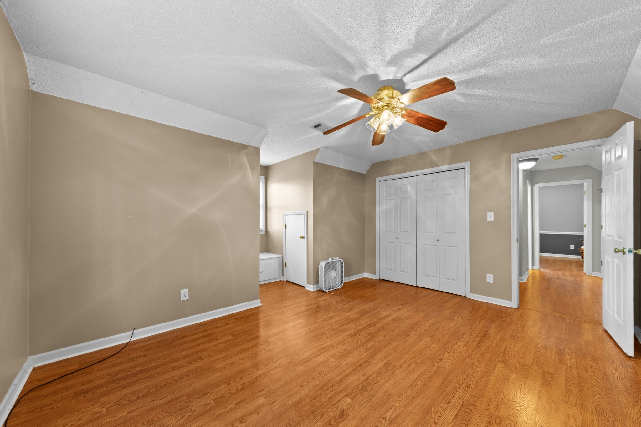 1336 Charlotte Drive Pulaski, TN 38478 - Photo 45 of 65 a view of a big room with wooden floor and a chandelier fan