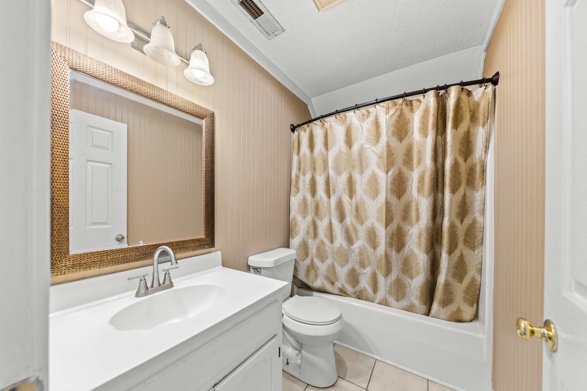 1336 Charlotte Drive Pulaski, TN 38478 - Photo 48 of 65 a bathroom with a sink a toilet and shower curtain