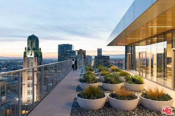 a view of a balcony with potted plants