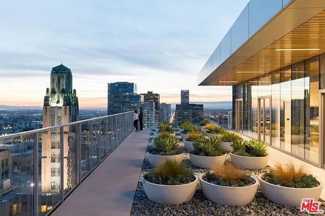a view of a balcony with potted plants