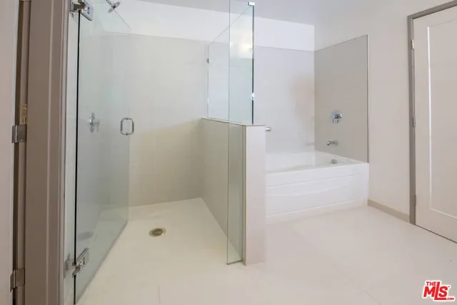 a bathroom with a bathtub and a shower