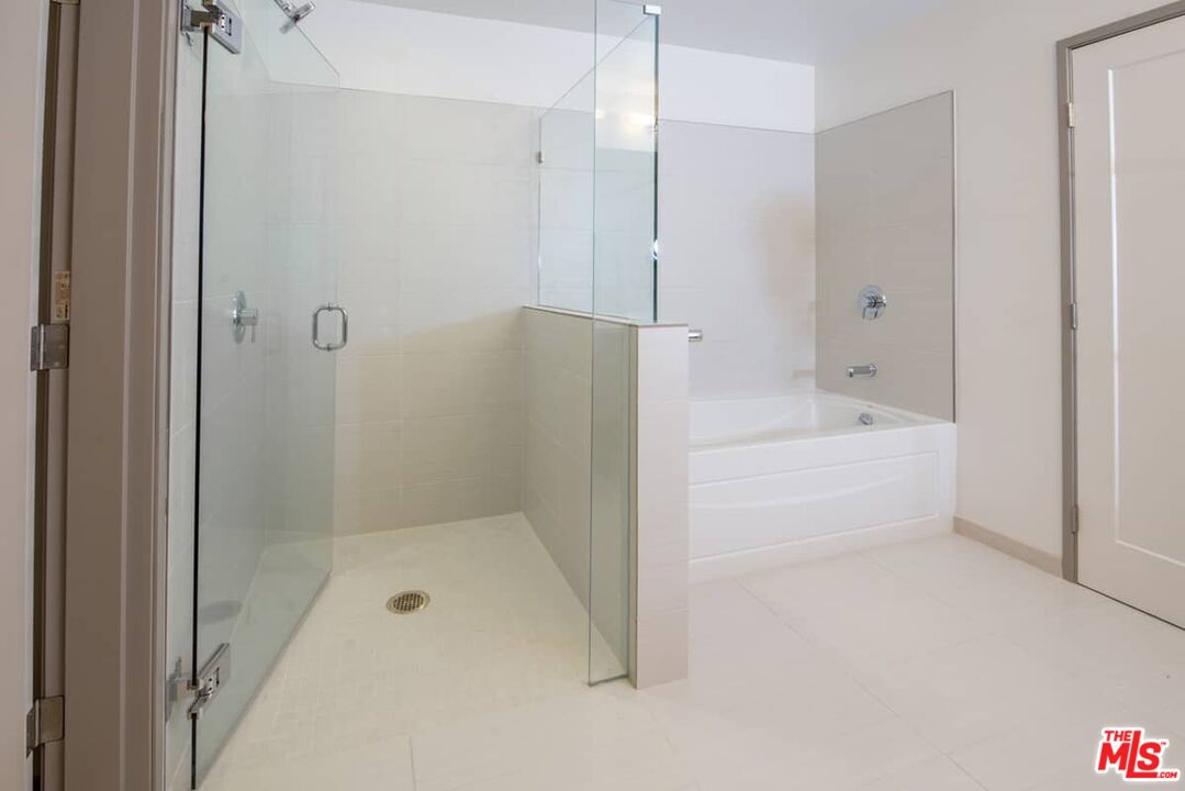 3033 Wilshire Boulevard, Unit 1707 Los Angeles, CA 90020 - Photo 14 of 32 a bathroom with a bathtub and a shower