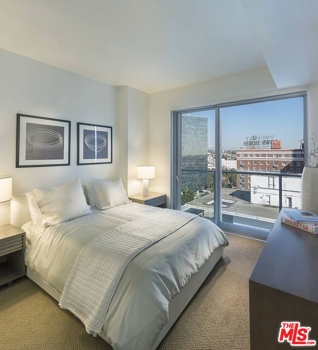 3033 Wilshire Boulevard, Unit 1707 Los Angeles, CA 90020 - Photo 15 of 32 a bedroom with bed and a large window