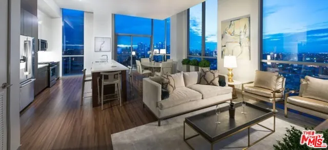 a living room with furniture a fireplace and a dining table with wooden floor