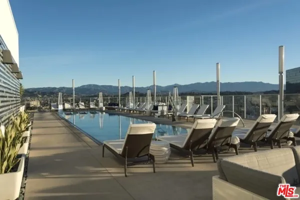 a view of a balcony with chair and tables