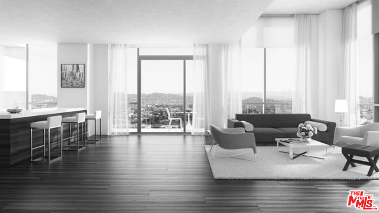 3033 Wilshire Boulevard, Unit 1707 Los Angeles, CA 90020 - Photo 4 of 32 a living room with furniture and floor to ceiling windows