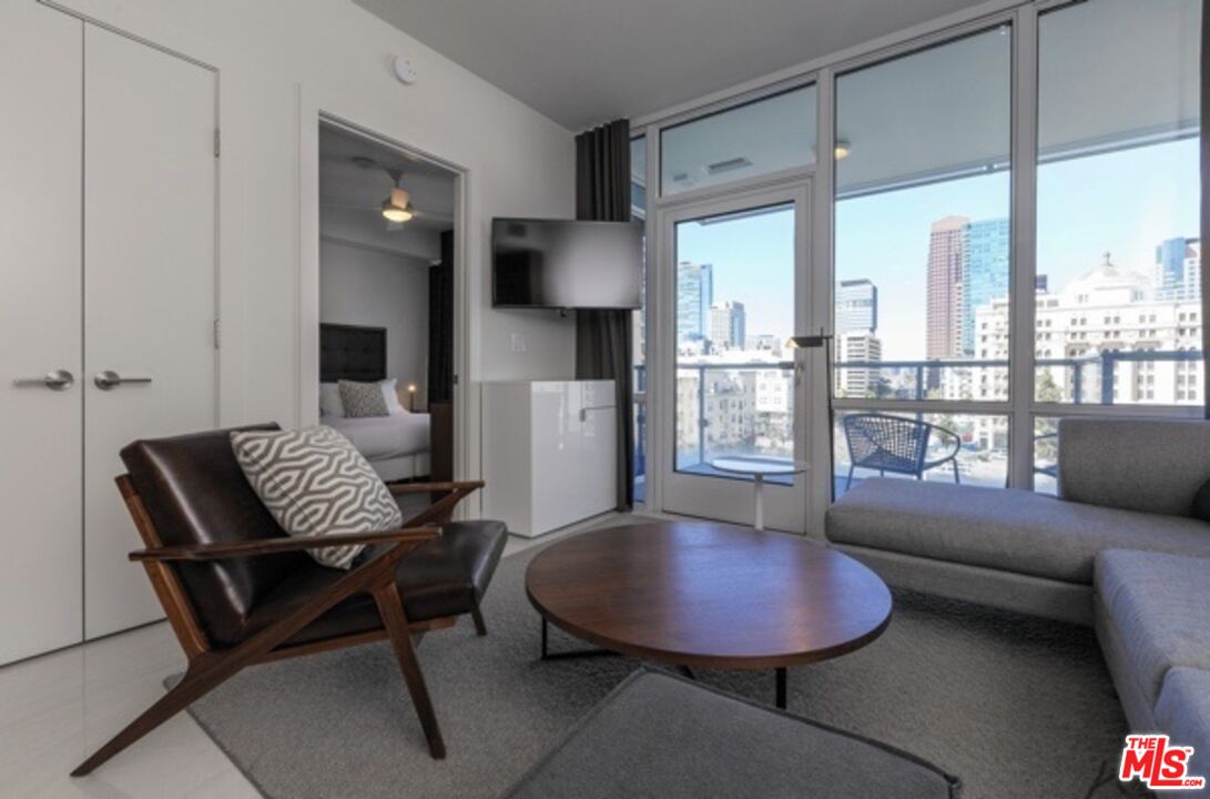 3033 Wilshire Boulevard, Unit 1707 Los Angeles, CA 90020 - Photo 7 of 32 a living room with furniture and a large window