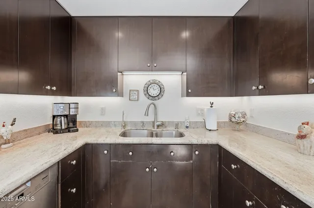 a kitchen with sink and cabinets