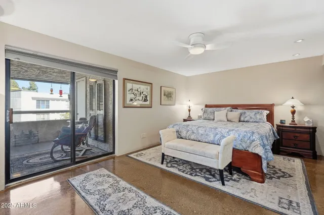 a bedroom with a bed and glass window