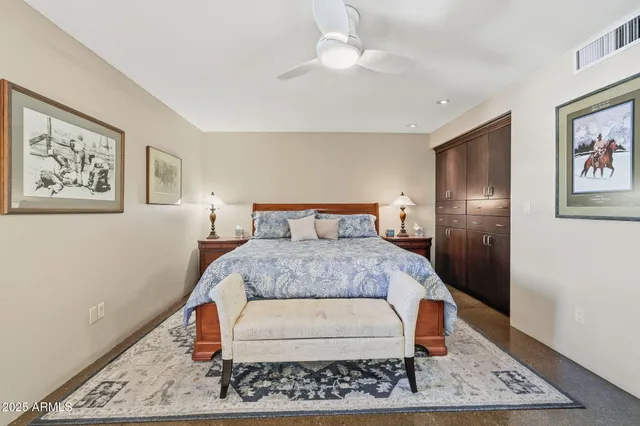 a bedroom with a large bed and a rug