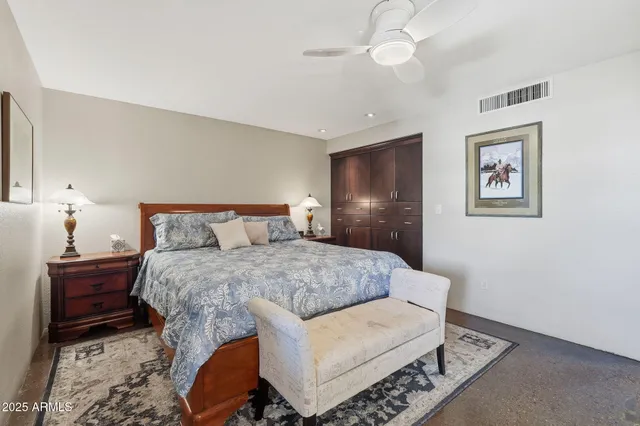 a bedroom with a bed couch and dresser