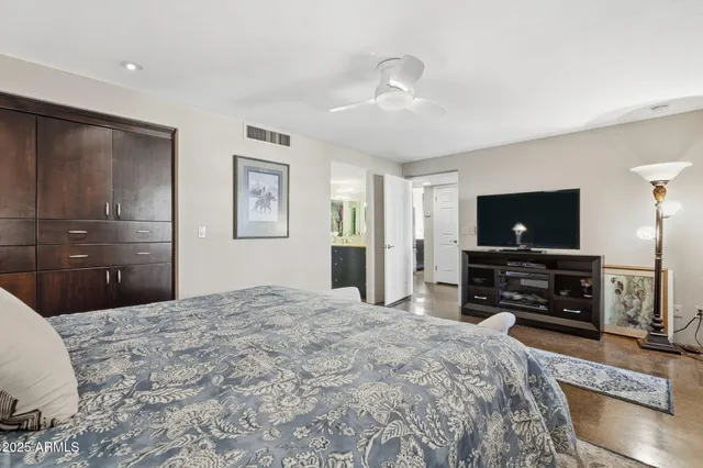 a bedroom with a bed and a flat screen tv