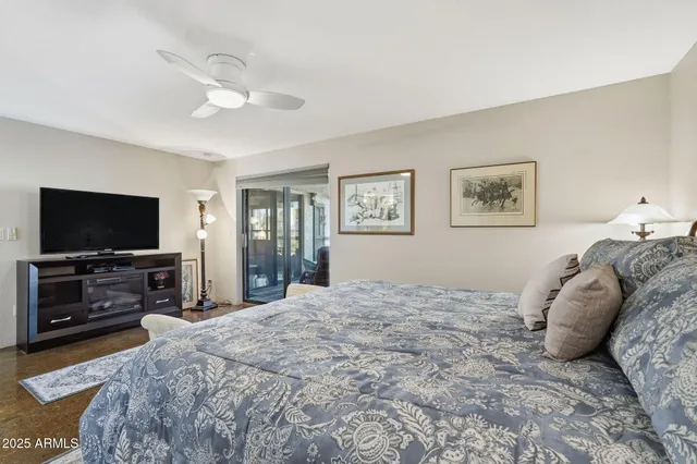 a bedroom with a bed and a flat screen tv