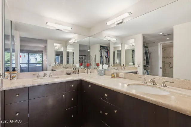 a bathroom with a double vanity sink and a mirror
