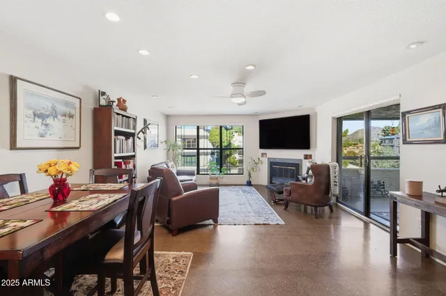 a living room with fireplace furniture and a flat screen tv