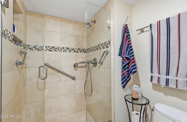 a bathroom with a shower and a shower