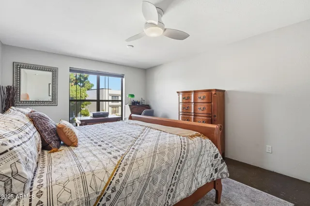 a bedroom with a large bed and a window