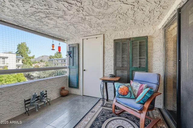 a view of a chair and table in the backyard