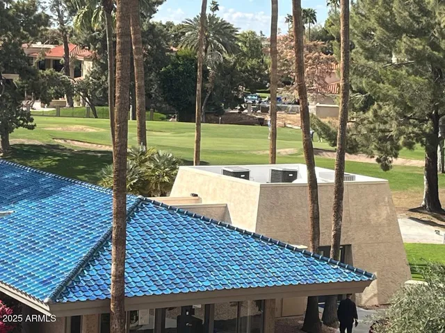 a view of a cafe with a table and chairs under an umbrella