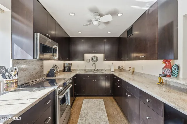 a large kitchen with a sink and a stove top oven