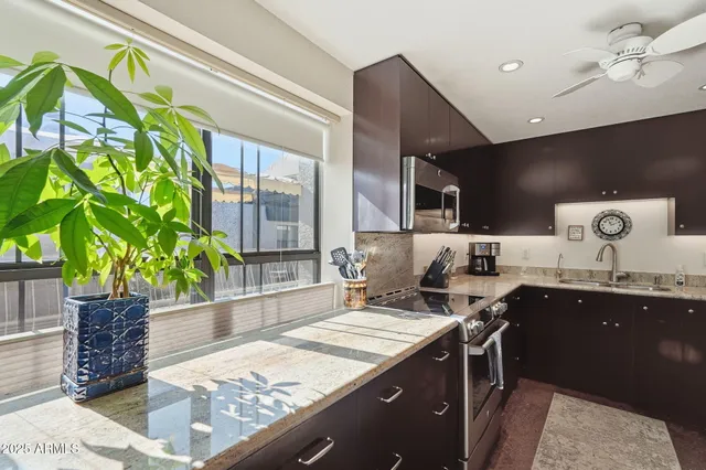 a kitchen with a sink a counter and cabinets