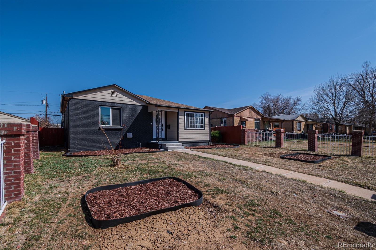 3360 Magnolia Street Denver, CO 80207 - Photo 2 of 31 a front view of a house with entertaining space