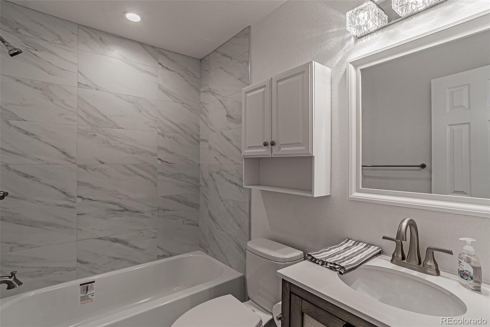 3360 Magnolia Street Denver, CO 80207 - Photo 10 of 31 a bathroom with a sink toilet and shower