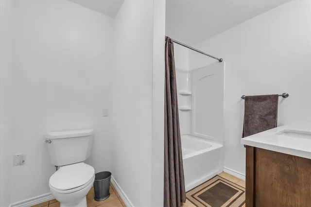 a white toilet sitting next to a bathroom sink