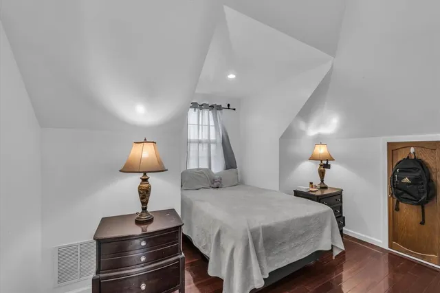 a bedroom with a bed and a lamp