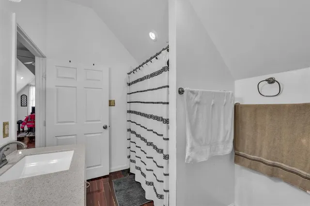 a bathroom with a tub sink and shower