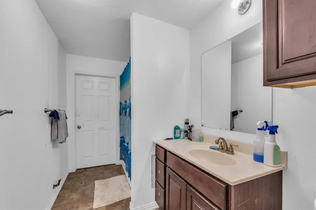 a bathroom with a sink vanity and a mirror