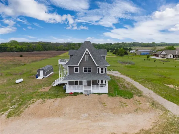 an aerial view of a house with big yard