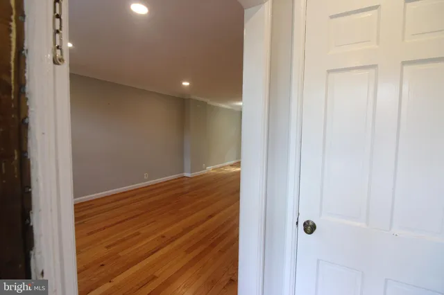 a view of hallway with wooden floor