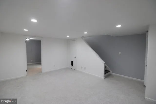 an empty room with a white wall and space