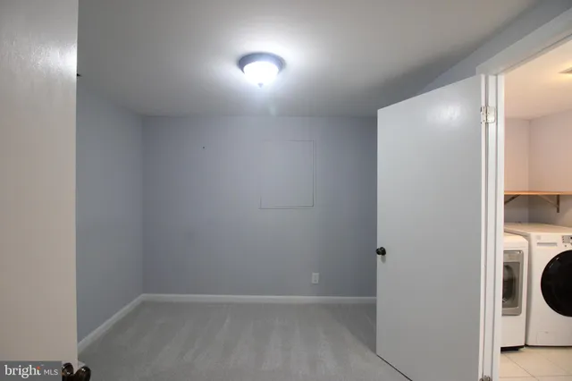 a view of a hallway with washer and dryer
