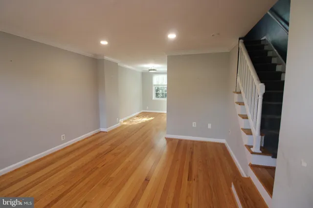 a view of a room with wooden floor and staircase